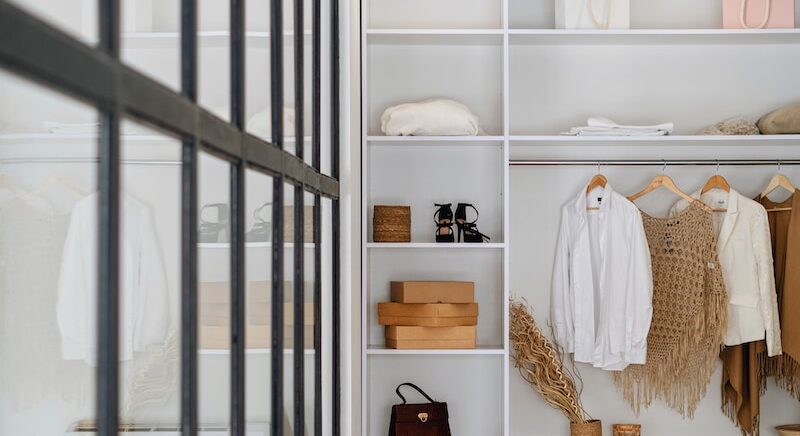 white bath towel on white wooden cabinet